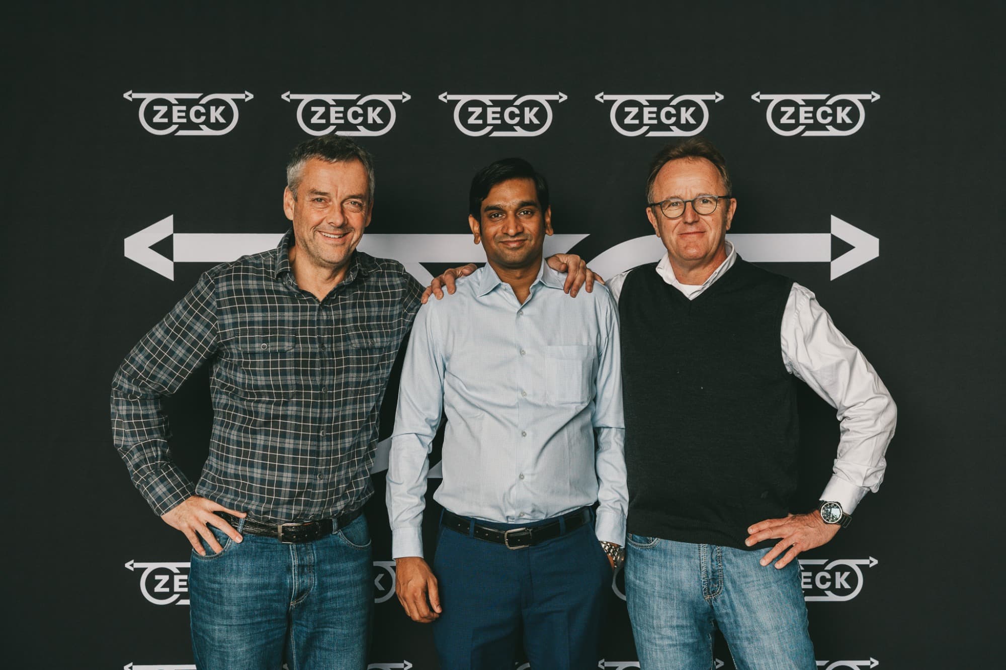 Michael Zeck, Sumit Chauhan and Dirk Braun-Friderici in front of a ZECK backdrop.
