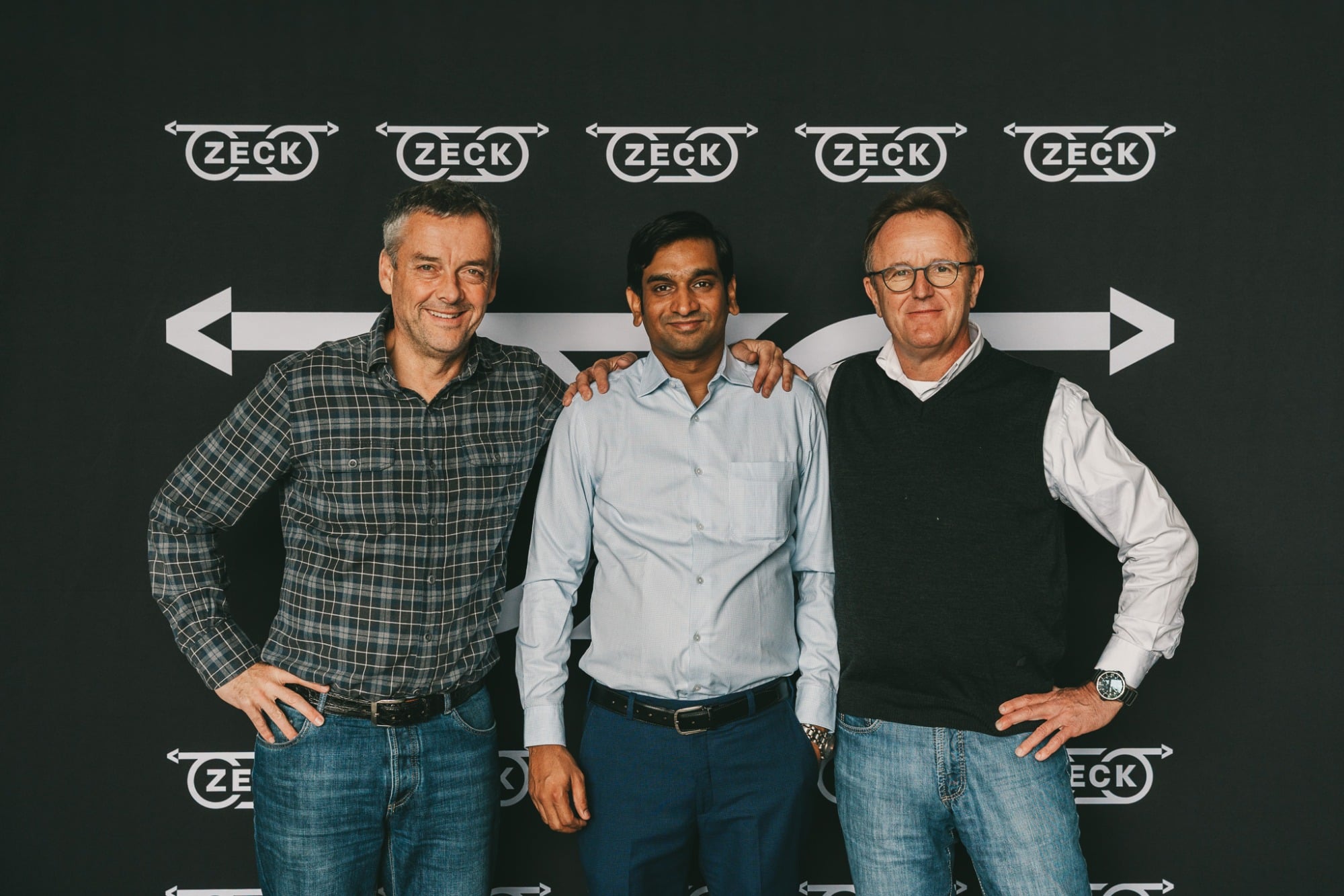 Michael Zeck, Sumit Chauhan and Dirk Braun-Friderici in front of a ZECK backdrop.