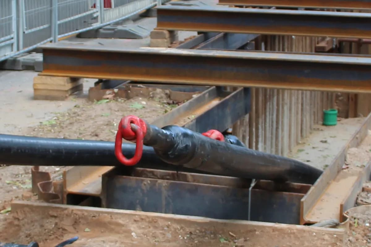 An underground cable being pulled into a cable trench