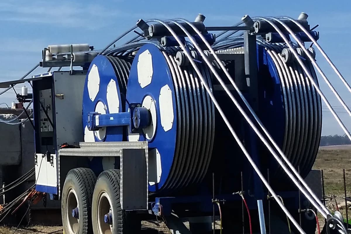 A ZECK drum winch stringing an overhead power line